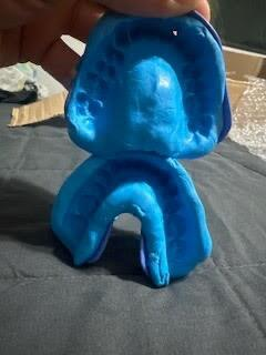 Blue impression held in a hand