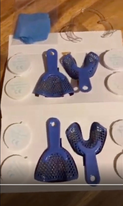 Blue impression trays laid out on a kit
