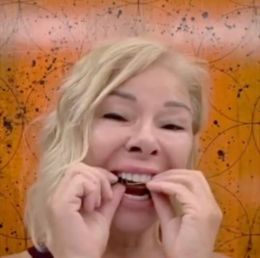 Woman placing a dental appliance in her mouth