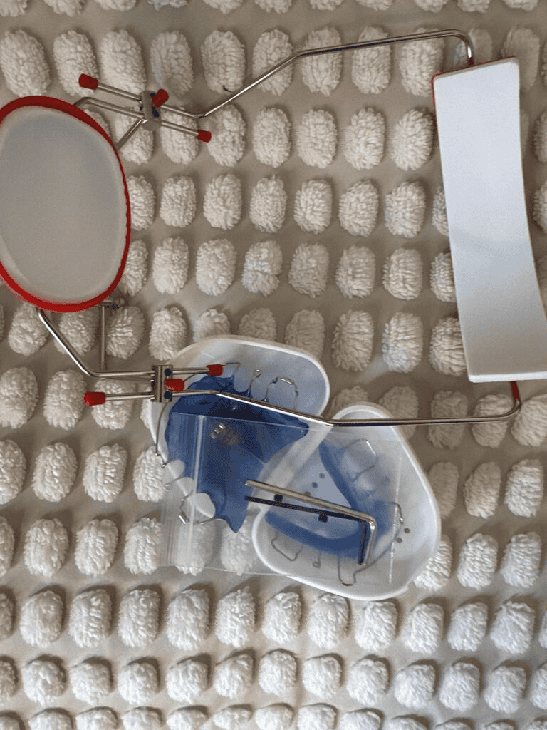 Dental appliances photographed on a textured surface